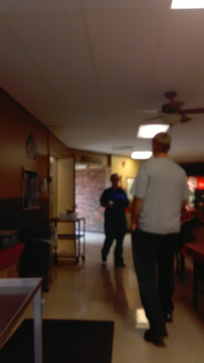 A candid moment in a restaurant with two individuals having a conversation.