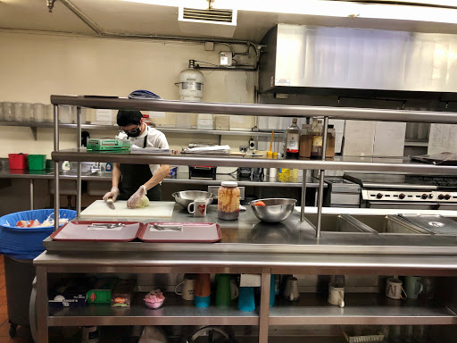 A chef busily preparing ingredients in a restaurant kitchen.