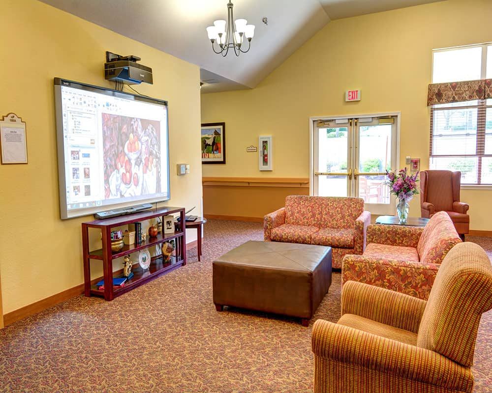 A cozy living room with comfortable seating and a large screen for entertainment.