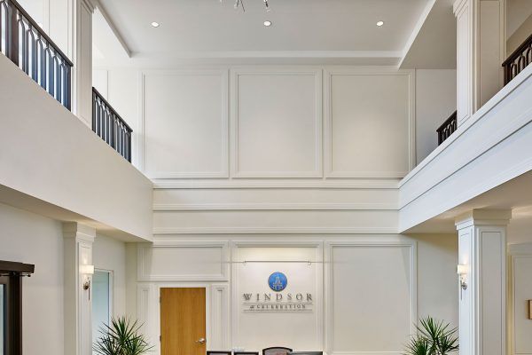 A modern office lobby with a reception desk and minimalist decor.