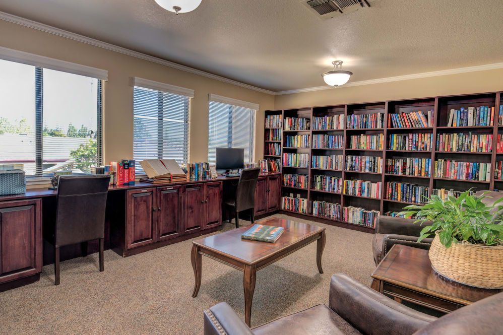 A cozy library with bookshelves and comfortable seating.