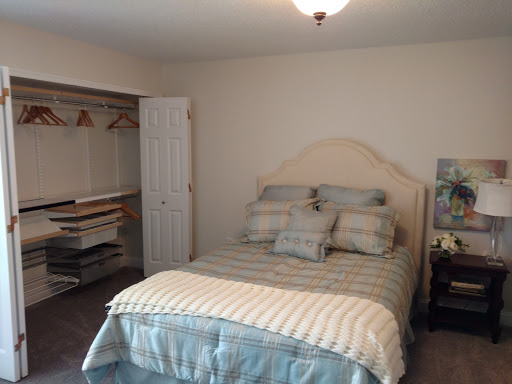 A cozy, well-arranged bedroom featuring a comfortable bed and a closet space.