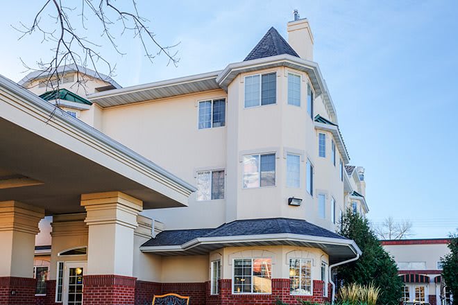 The image shows the exterior of a multi-story building with architectural features and windows.