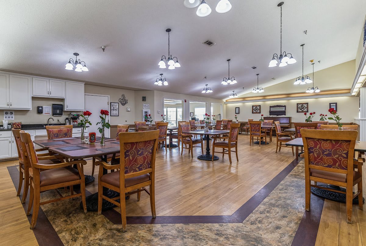 A spacious dining area with wooden furniture and ambient lighting.
