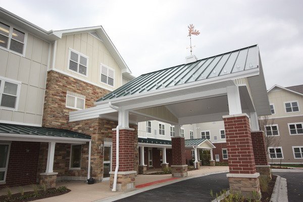A modern residential building with a covered entrance and attractive architecture.