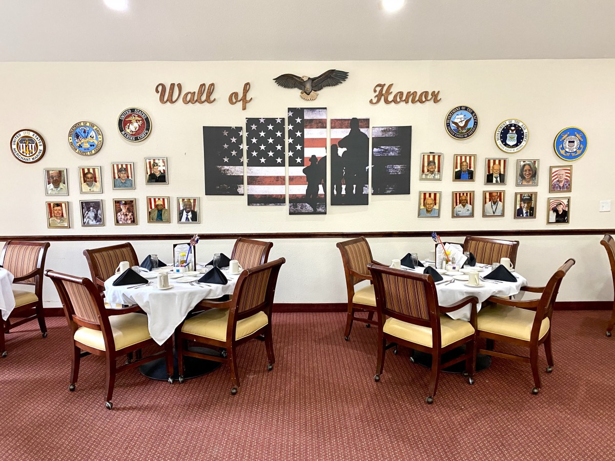 A dining area featuring a Wall of Honor with military tributes and an American flag theme.