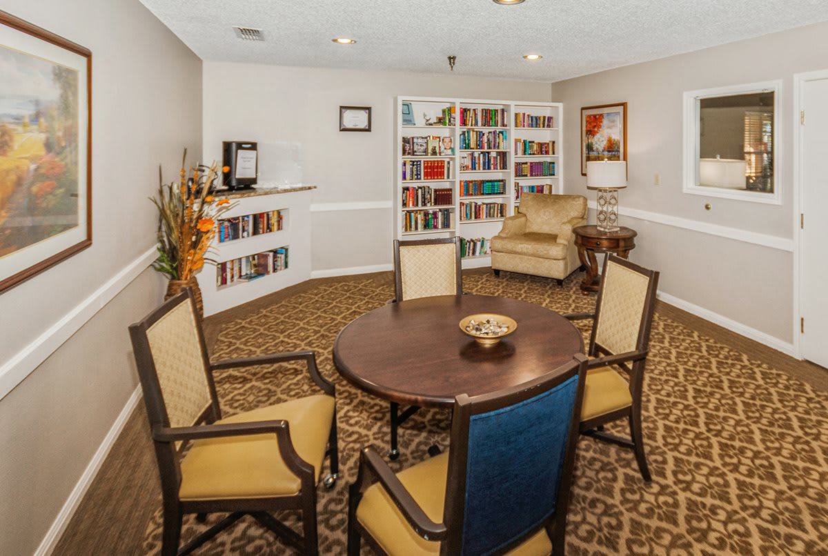 A cozy library room with bookshelves and a seating area.