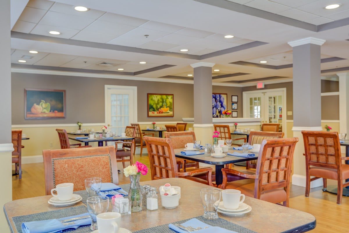 A well-appointed dining area with neatly set tables and comfortable seating.