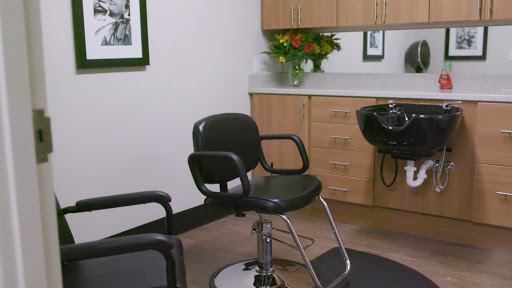 A modern hair salon featuring a styling chair and elegant decor.