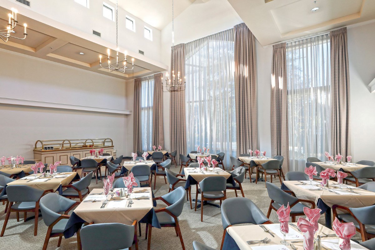 A modern and elegant restaurant dining area with well-arranged tables and chairs.