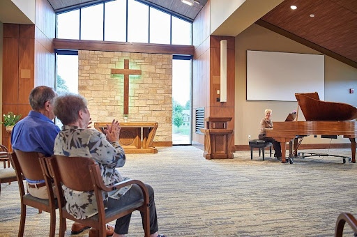 A serene moment of worship in a church setting, with members gathered for music and prayer.