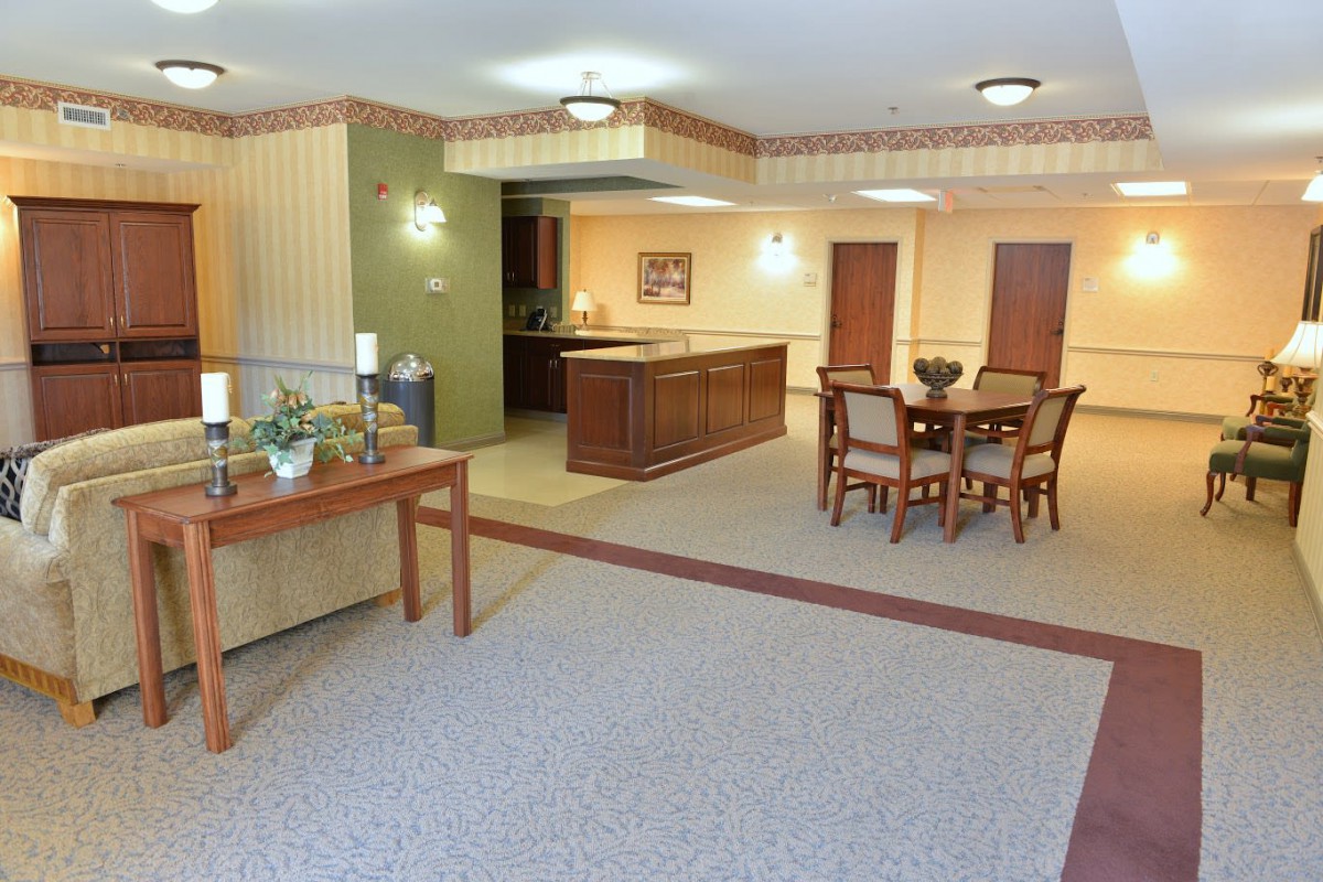 A well-lit lobby area with seating and a decorative table.