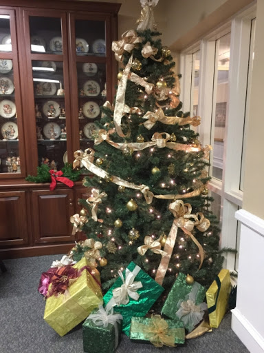 A beautifully decorated Christmas tree surrounded by colorful gifts, adding a festive touch to the room.