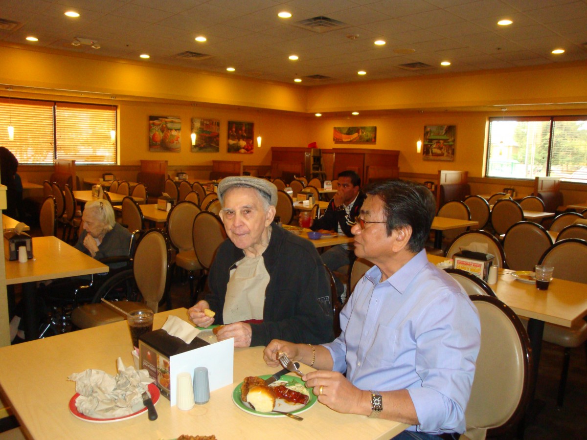 Two people enjoying a meal and conversation in a restaurant setting.