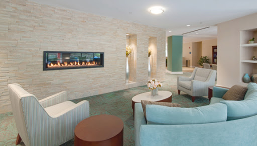 A stylish and modern living room featuring a sleek fireplace and comfortable seating.
