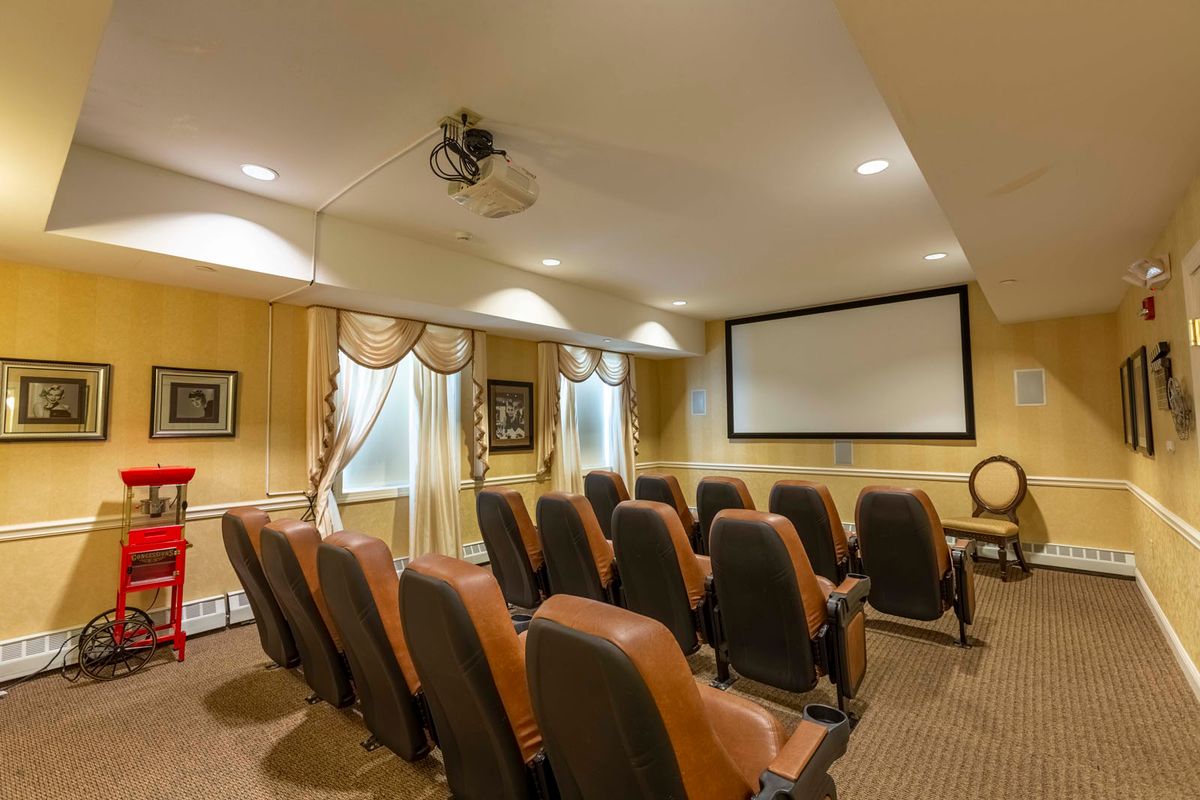 A cozy home theater setup with comfortable seating and a large screen.