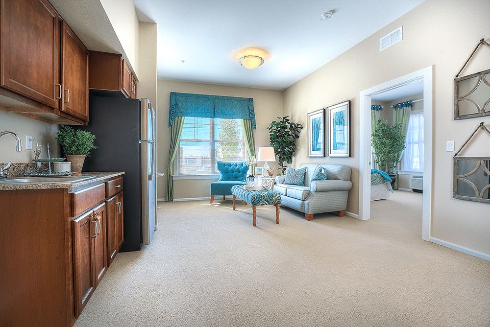A bright and cozy living room with a comfortable sofa, elegant curtains, and neatly arranged furniture.