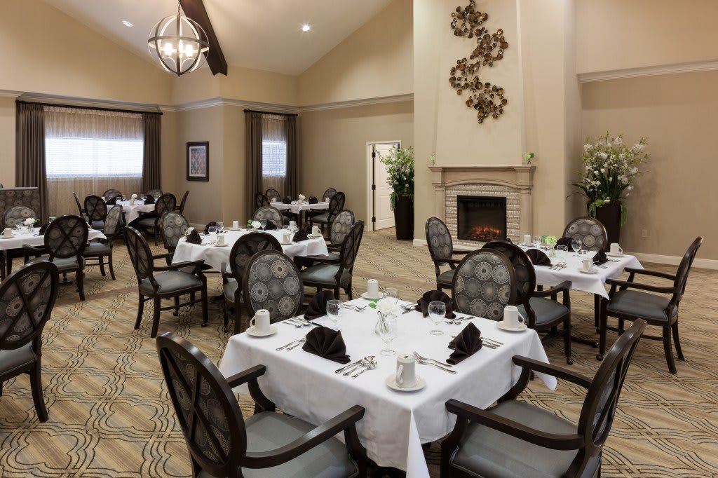 An elegant dining area with tastefully set tables and comfortable seating.