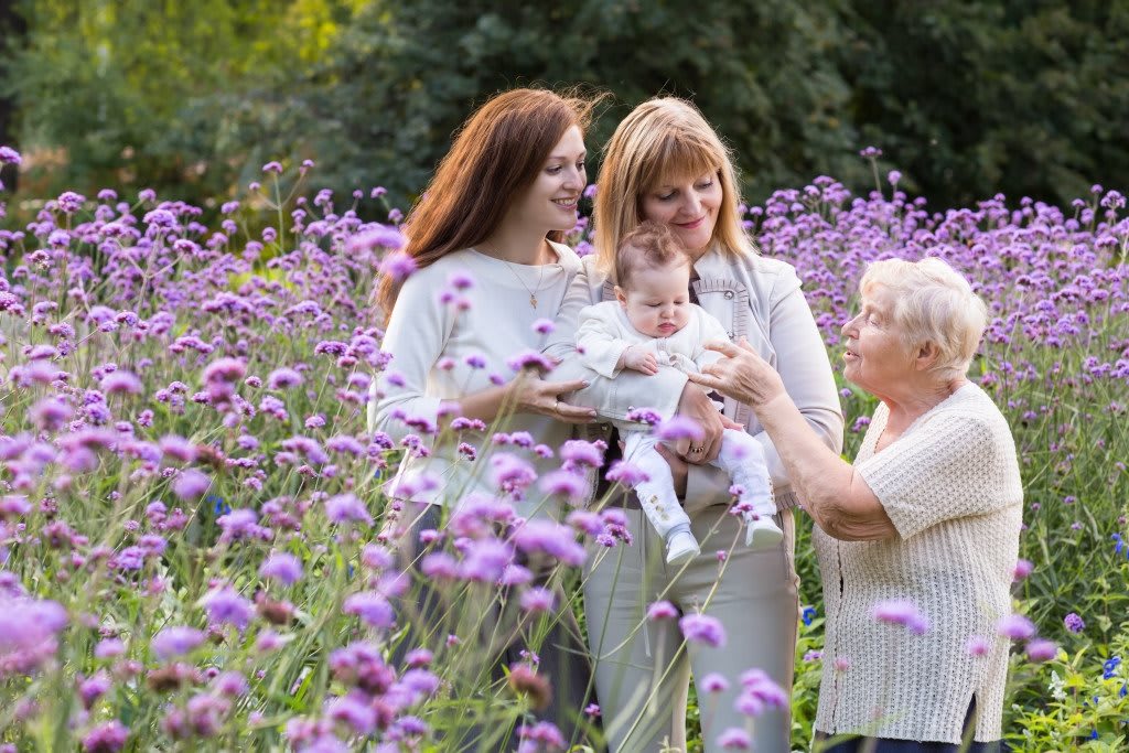 A family enjoying time together in a field of purple flowers.