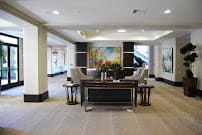 A modern lobby with elegant furniture and artwork on the walls.