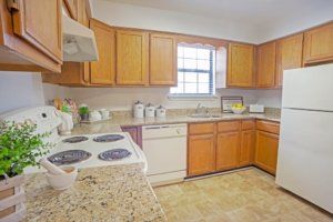 A cozy kitchen interior with wooden cabinets and modern appliances.