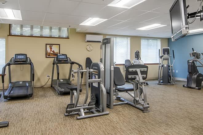 A well-equipped fitness center with various exercise machines.