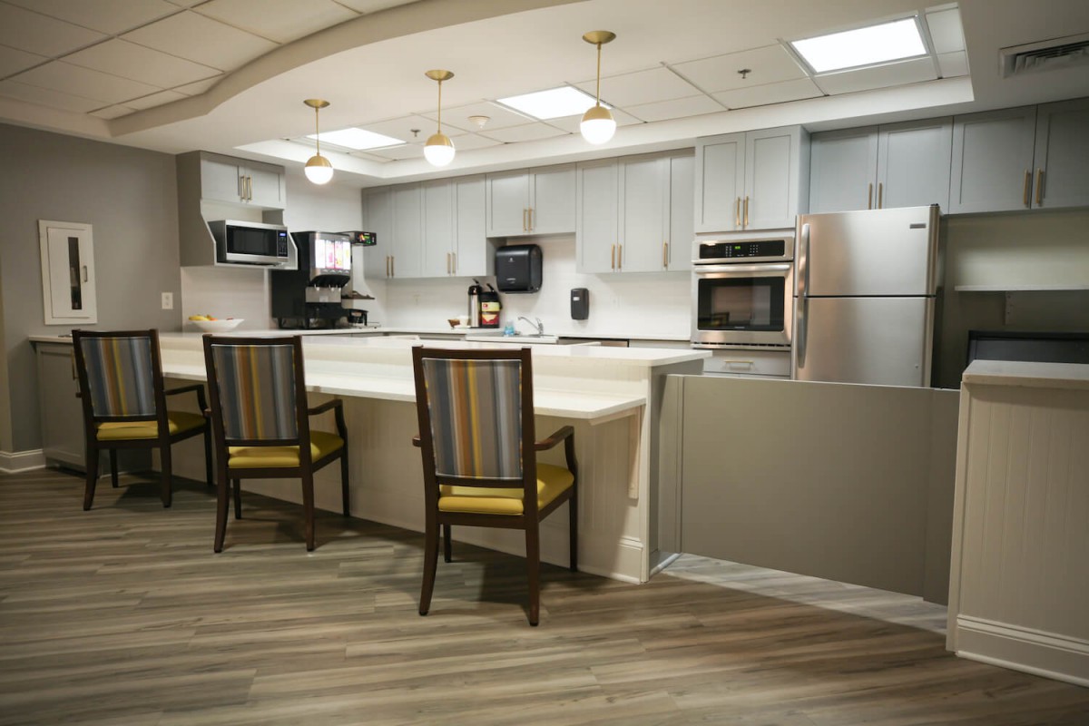 A modern kitchen interior featuring sleek appliances, a spacious countertop, and stylish seating.