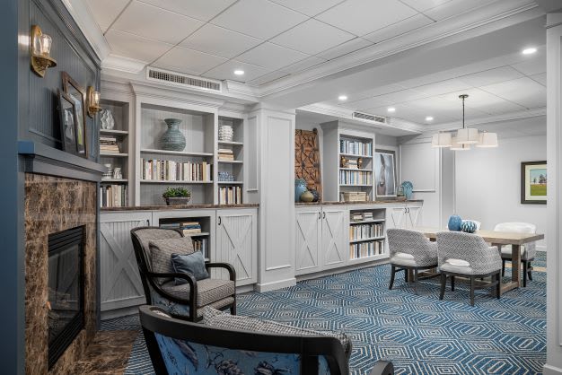 A modern and cozy living room with built-in bookshelves and comfortable seating.