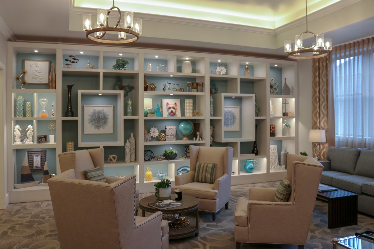 A modern living room with comfortable seating and stylish bookshelves.