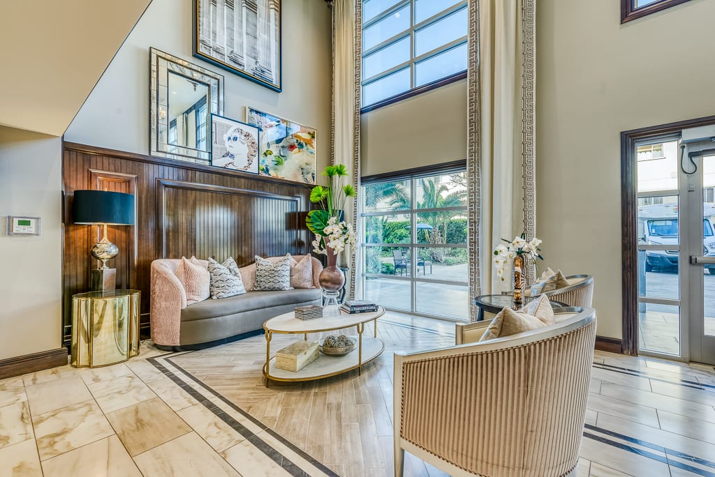 A luxurious and modern living room with high ceilings and elegant furnishings.