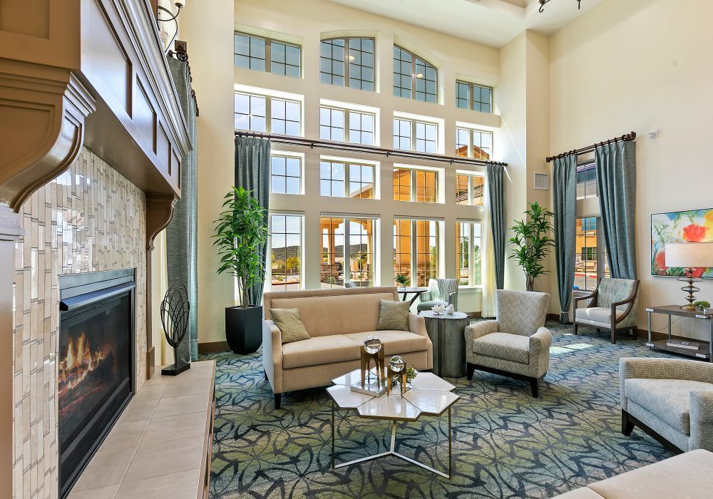 A bright and modern living room with large windows, comfortable seating, and stylish decor.