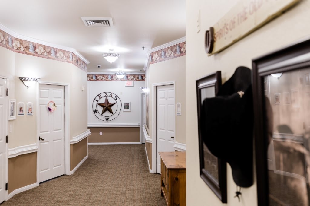 A hallway decorated with a cowboy hat and star-themed wall art.