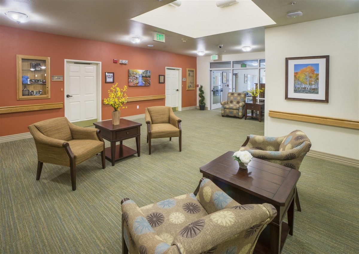 A modern lounge area with comfortable seating and artwork on the walls.