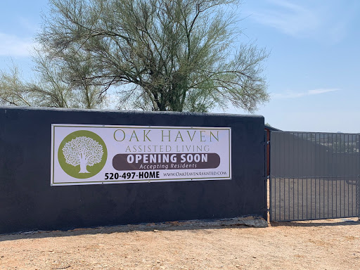 A sign indicating the upcoming opening of Oak Haven, featuring a tree logo and contact information.
