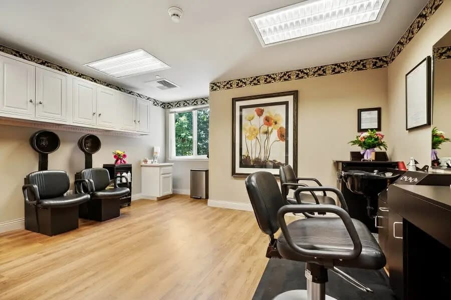 A bright and modern hair salon interior with styling chairs and mirrors.
