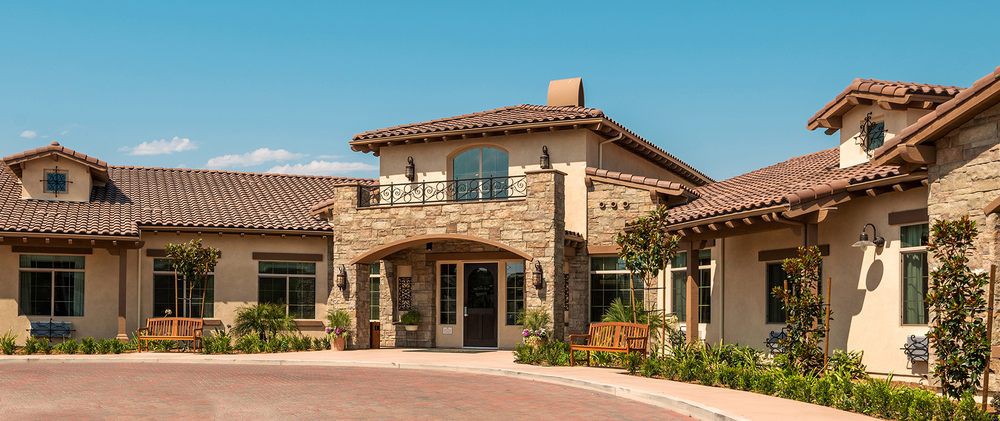 A beautiful residential building with a stone facade and tiled roof.