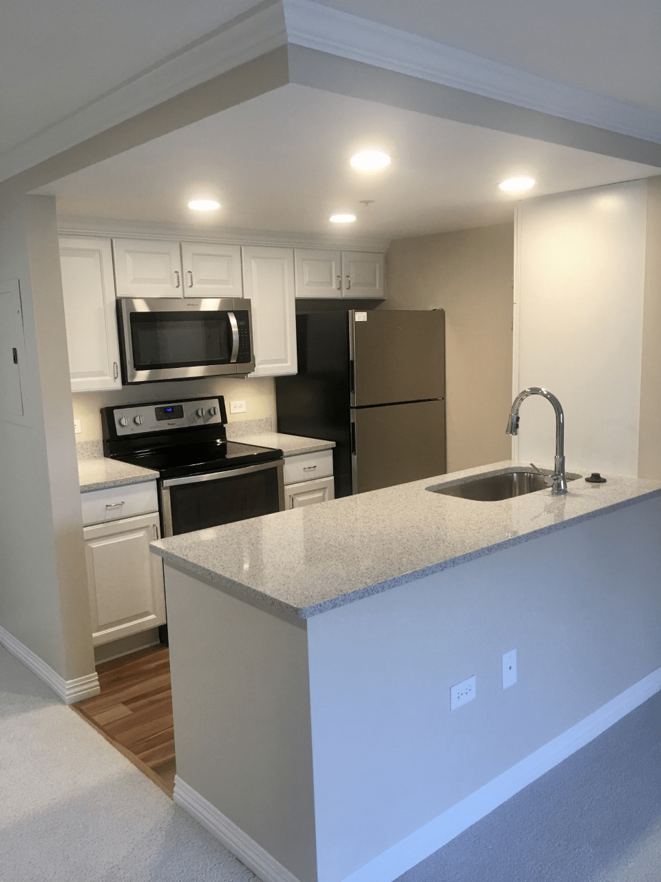 A modern kitchen with stainless steel appliances and a sleek countertop.