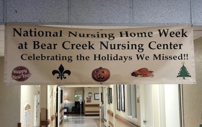 A banner in a hallway celebrating various holidays at Bear Creek Nursing Center.