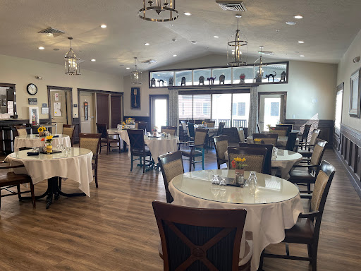 A spacious and elegantly designed restaurant interior with well-set tables ready for dining.
