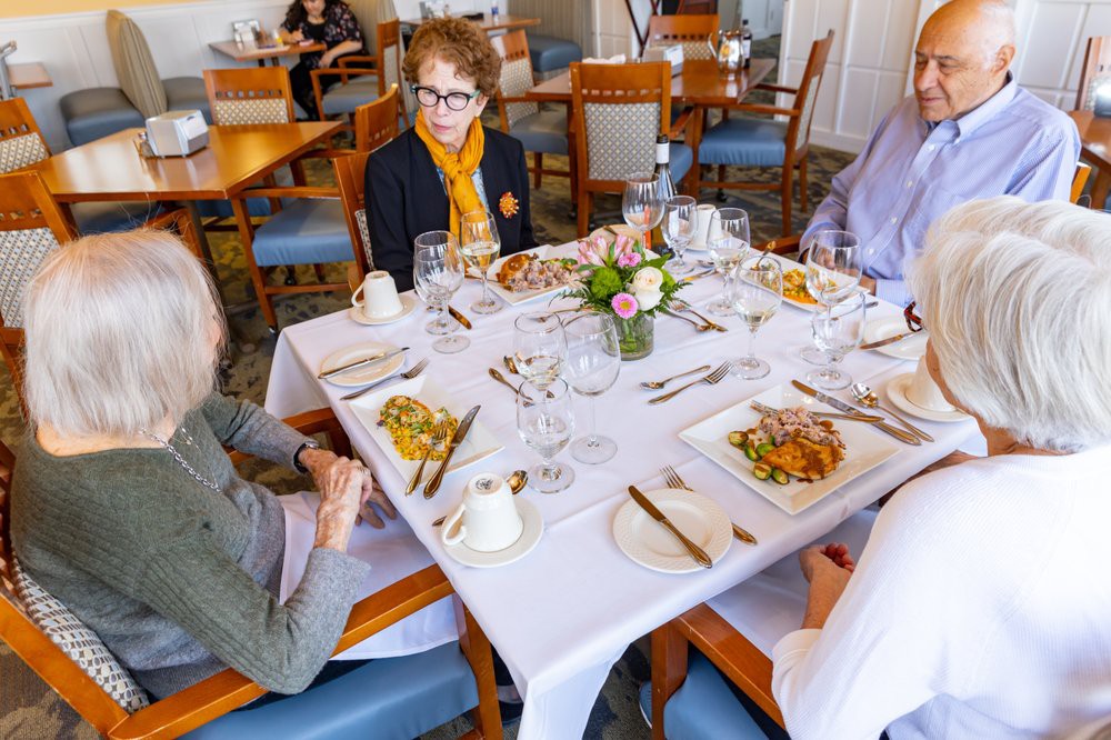 A group of people enjoying a meal together at a restaurant table.