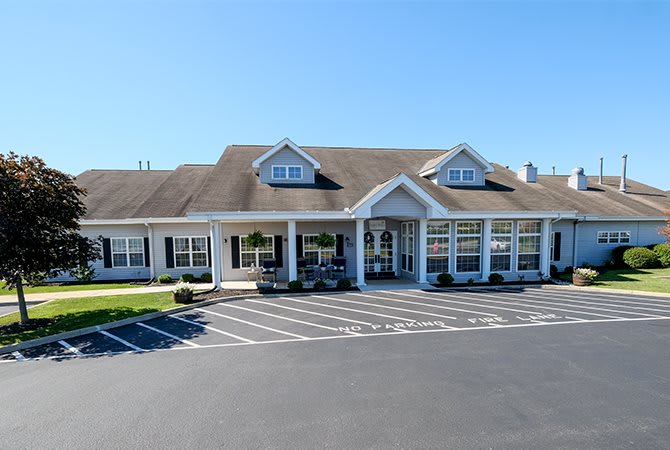 A suburban commercial property with a spacious parking lot and classic architectural design.