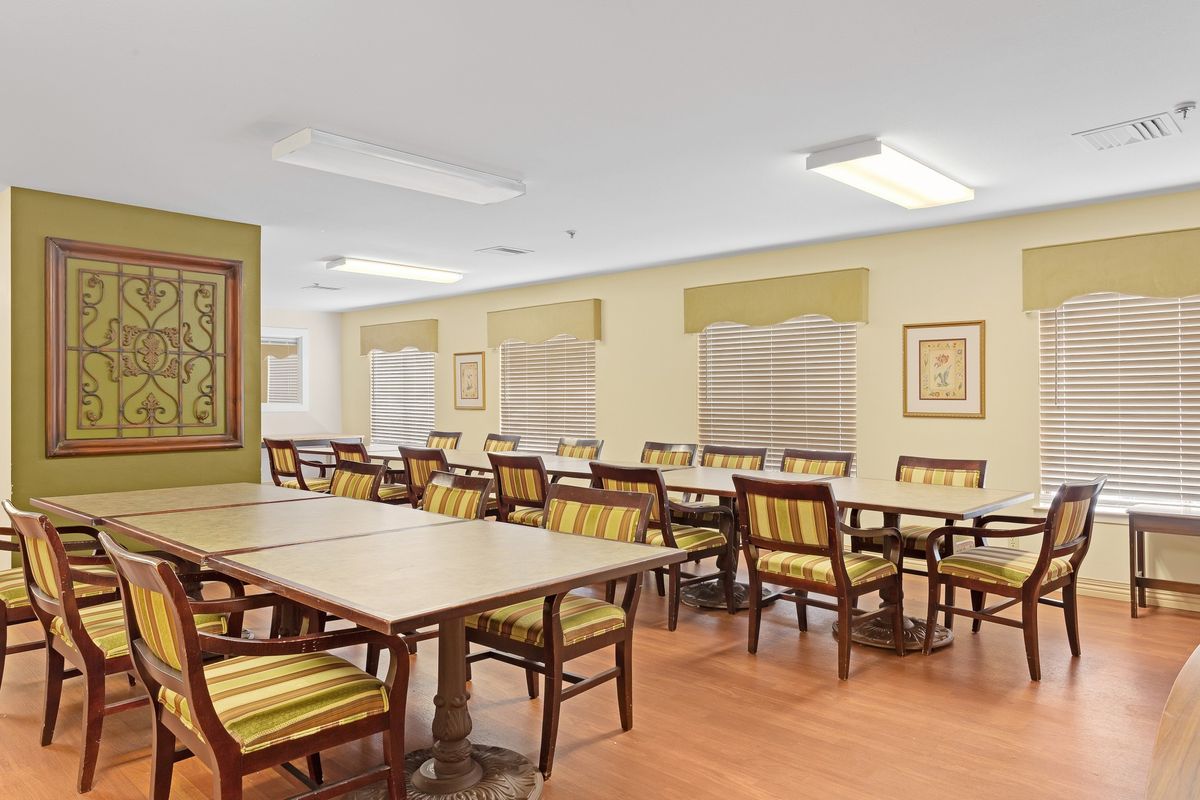 A spacious dining area with multiple tables and chairs arranged neatly.