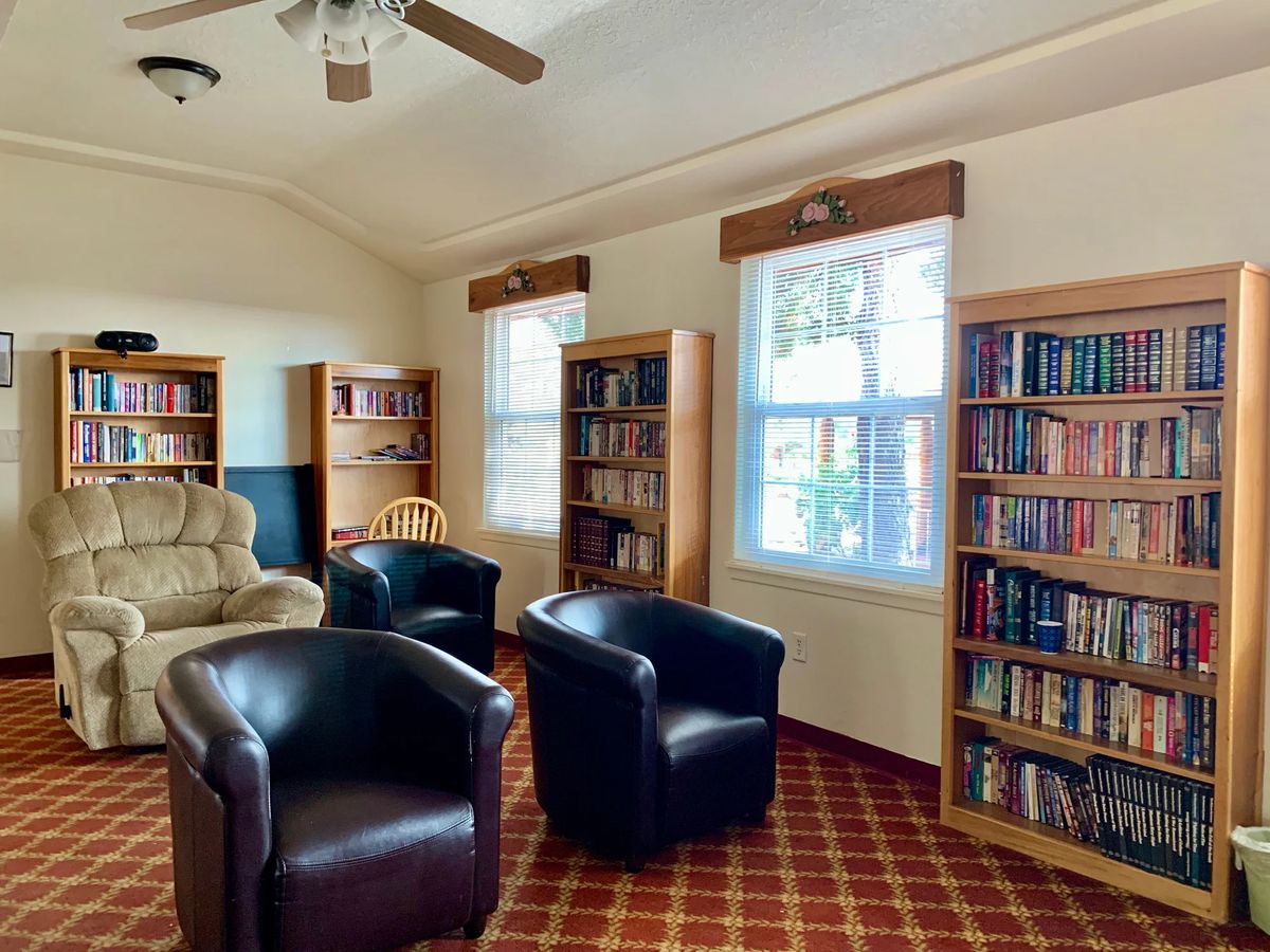 A cozy library reading area with bookshelves and comfortable seating.