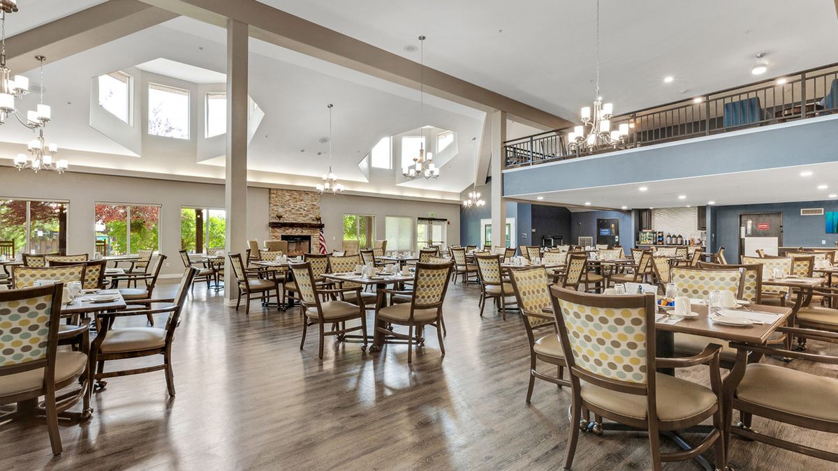 Spacious dining area with elegant chandeliers and ample natural light.