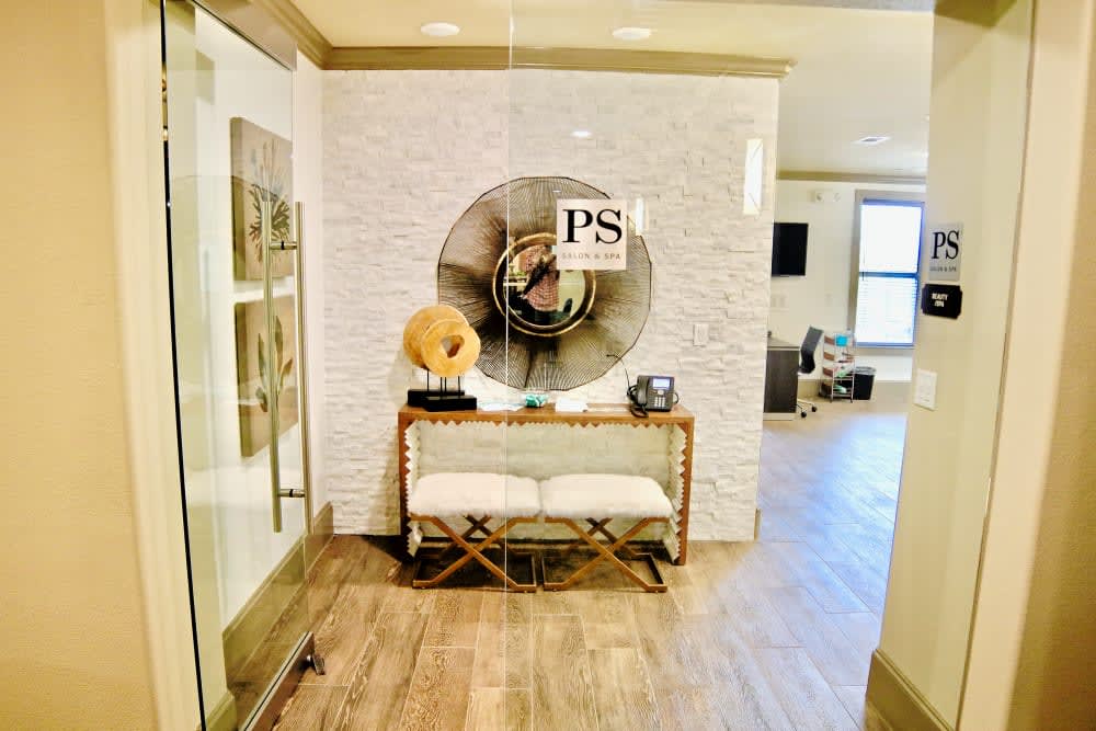A stylish entrance hall featuring modern decor with a wooden floor and eye-catching wall art.