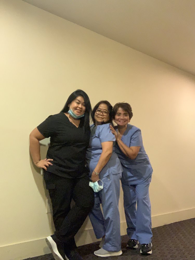 A group of healthcare professionals posing together in scrubs.