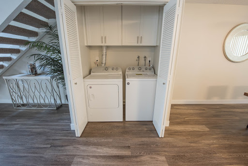 A compact laundry area featuring a washer and dryer within a storage closet.