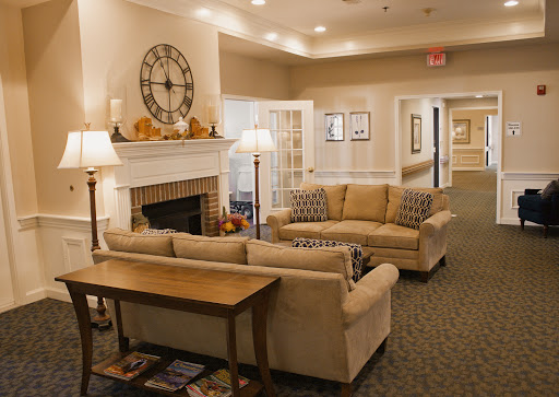 A welcoming living room with a cozy atmosphere, featuring comfortable sofas and a fireplace.