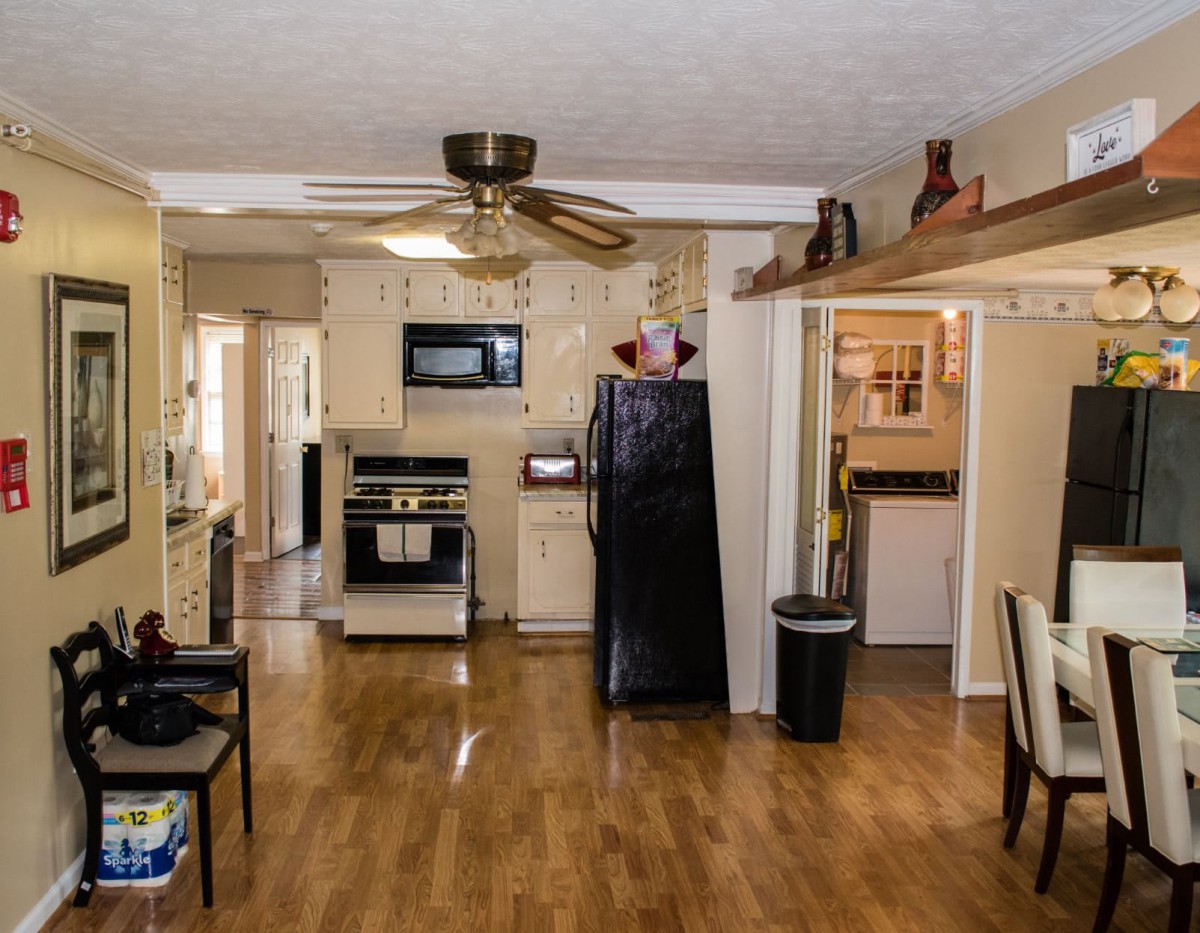 A cozy kitchen and dining area with wood flooring and modern appliances.