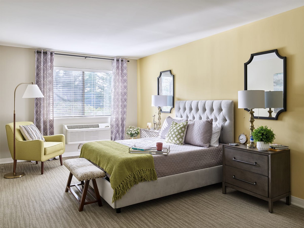 A modern bedroom with stylish decor and natural lighting.